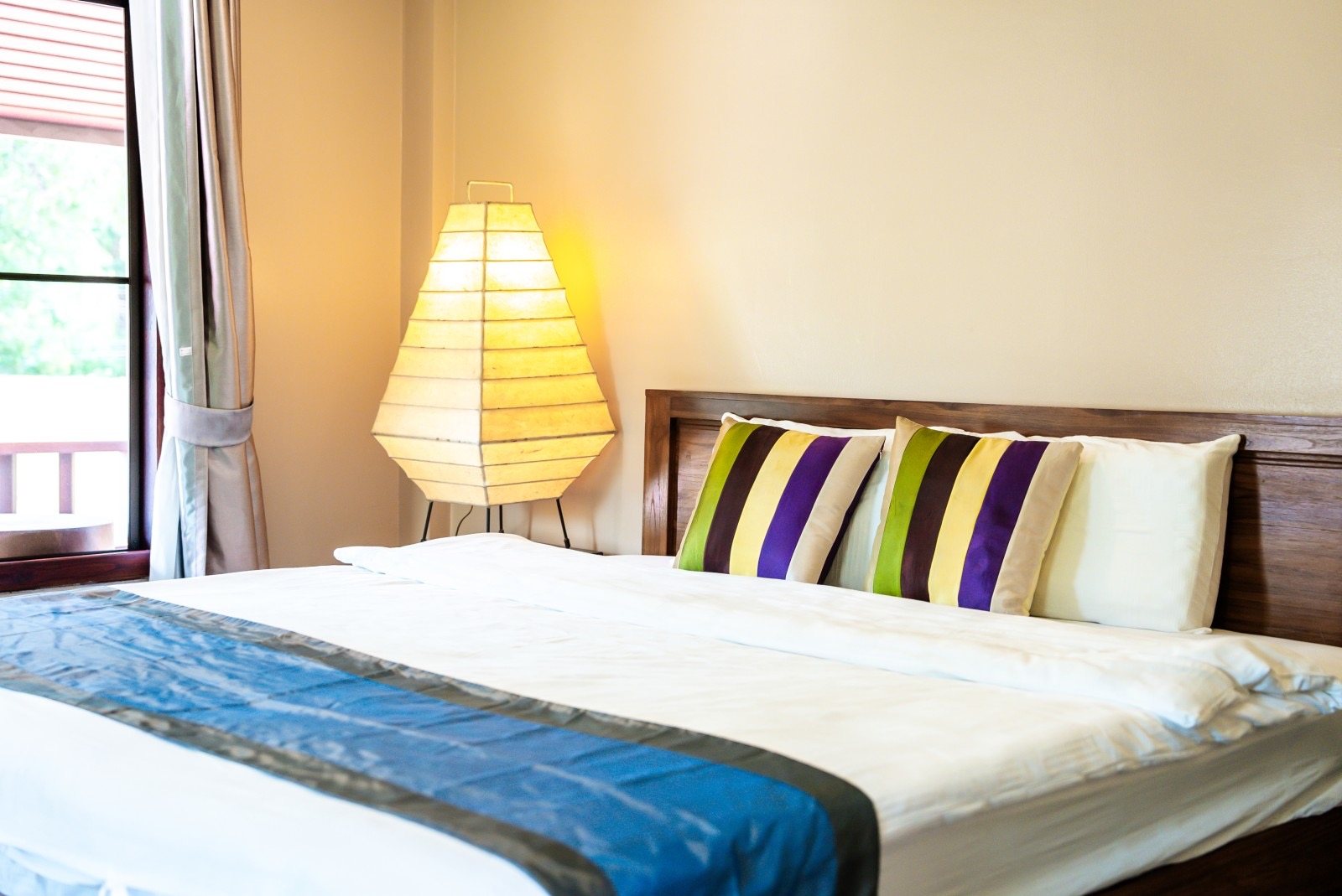 A guest room with a paper lantern