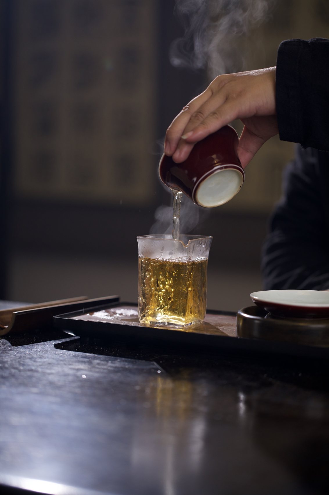 Steam rising as hot water is poured into a glass