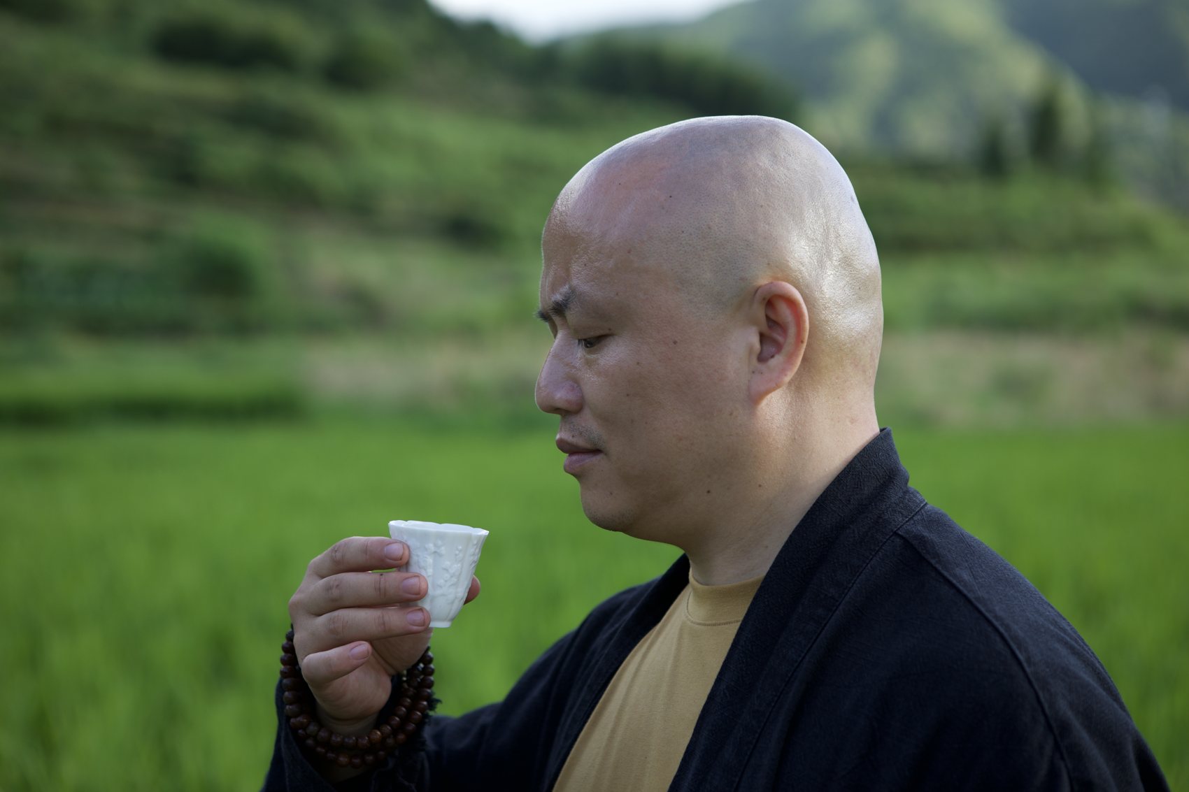 Ernan drinking tea in the rice fields of West Kun