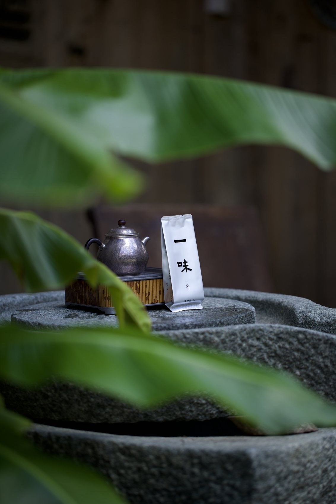 A kettle and tea bag resting on a stone basin