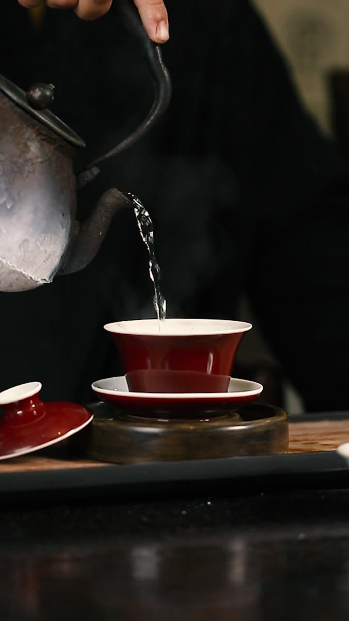 Pouring tea by lamplight