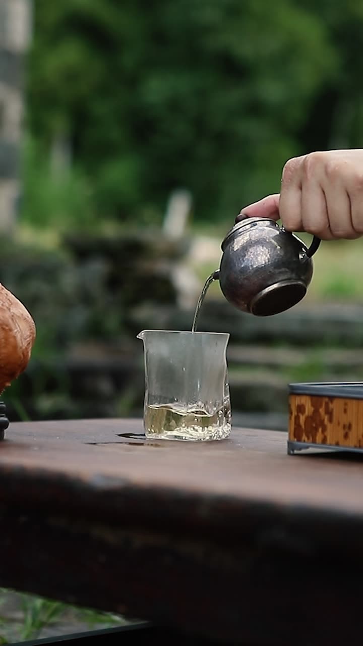 Pouring tea beside the rice fields of West Kun
