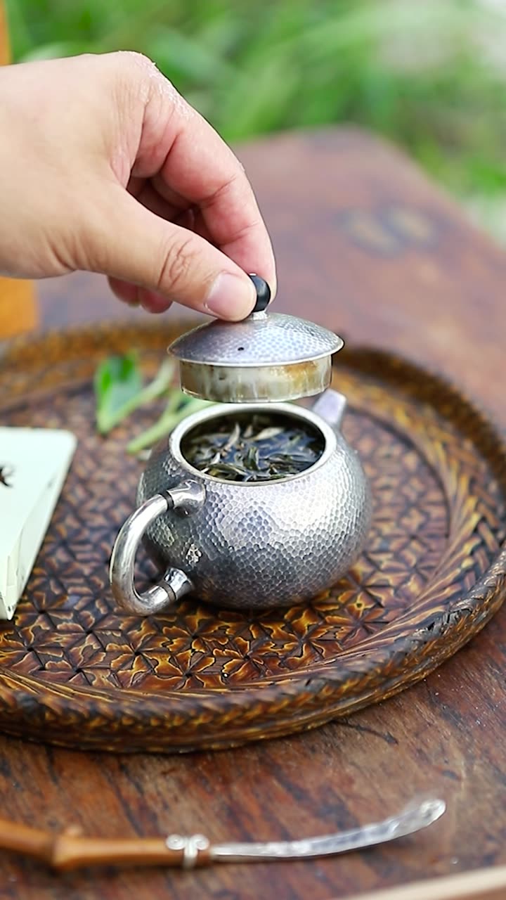 Pouring from the silver kettle beside the rice field